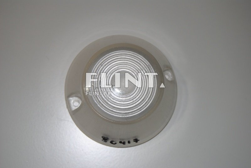 Ümar, läbipaistev plastkaar, mille keskel on kumer ja seest ringikujuline reljeef. Kaaril on kaks augukest, mis võimaldavad kinnitamist.