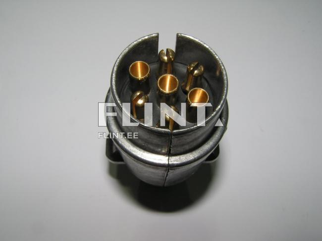 Ümar metallist pistik, millel on kuus pronksist kontakti, paigutatud ühtlaselt sisemusse.