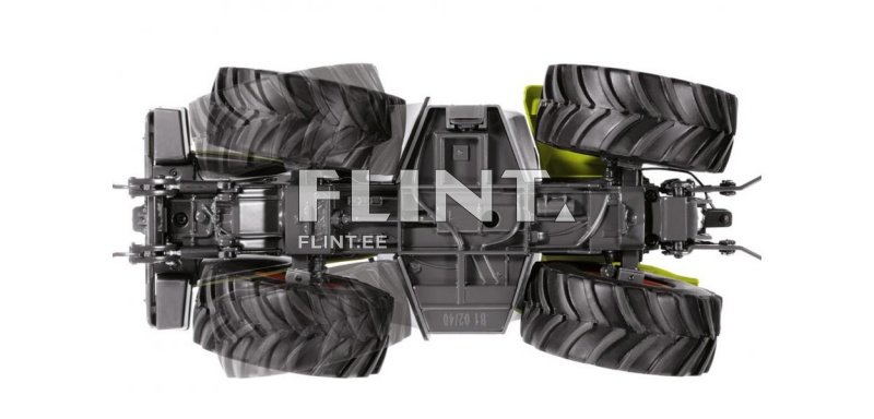 Pildi ülaosas on traktor, millel on suured mustad rehvid. Traktori raam on hall, koos erinevate rooste ja mehhanismidega. Tagapool on kergelt roheline osa, mis tõenäoliselt tähistab traktori keha.