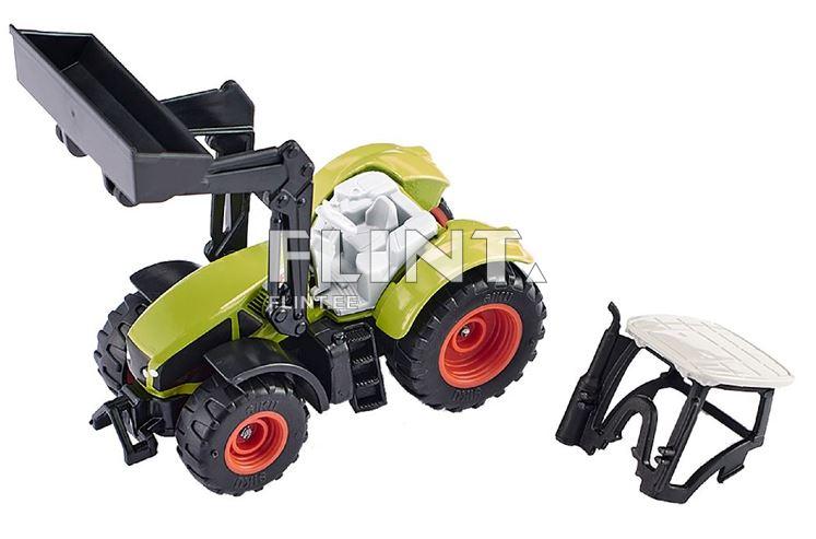 Mudeltraktor on roheline plasttoode, millel on must kuhil ja erksad punased rattad. Traktoril on liigend, mis võimaldab kuhilat liigutada.