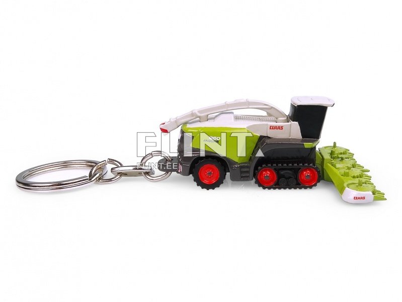 Miniatuurne kogumismasin, millel on roheline ja must korpus, punased rattad ja valge lõpposa. C Laasi logo on nähtav külgedel.